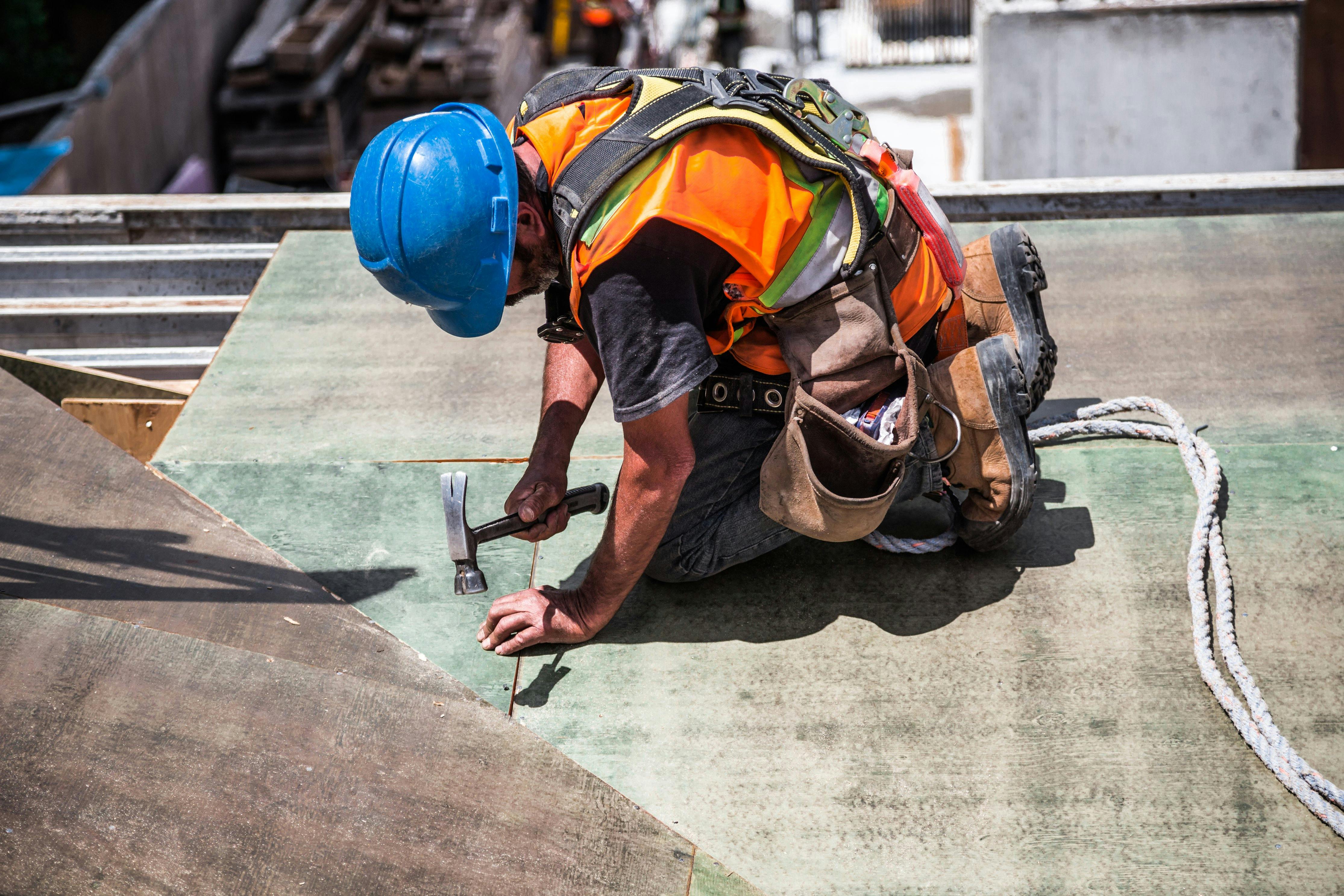 Professional roofer working on flat roof installation